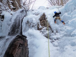 Feeling the power of nature in front of a frozen waterfall.